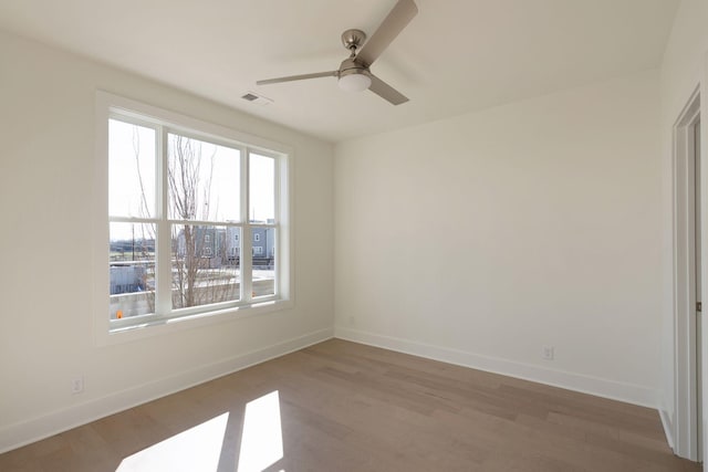 unfurnished room featuring hardwood / wood-style flooring and ceiling fan