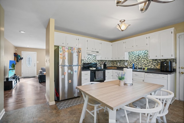 kitchen with white cabinetry, black electric range oven, stainless steel fridge, and white dishwasher