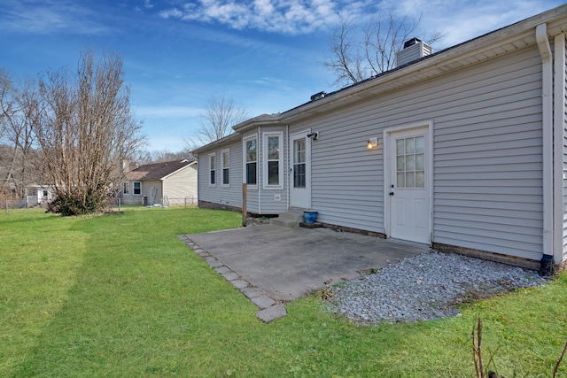 back of house featuring a patio and a lawn