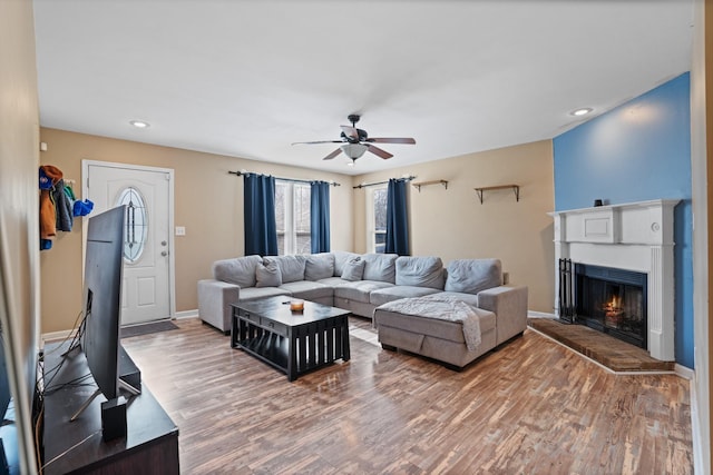 living room featuring ceiling fan and hardwood / wood-style floors