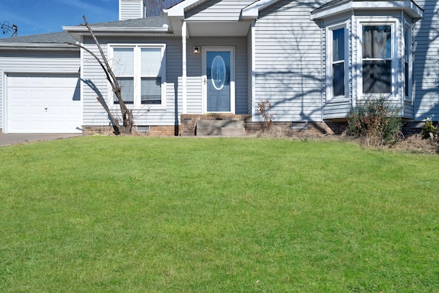 view of front of home featuring a garage and a front lawn