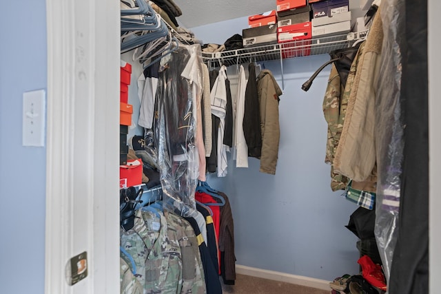 walk in closet featuring carpet flooring