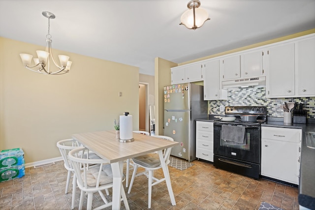 kitchen featuring stainless steel fridge, tasteful backsplash, white cabinets, black range with electric cooktop, and decorative light fixtures