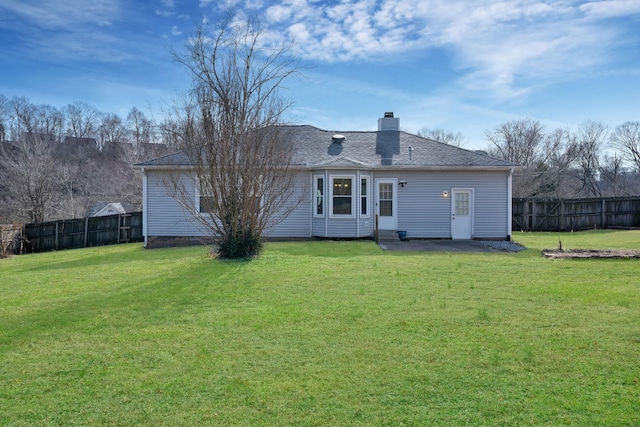 rear view of house featuring a lawn