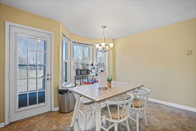 dining space with a notable chandelier