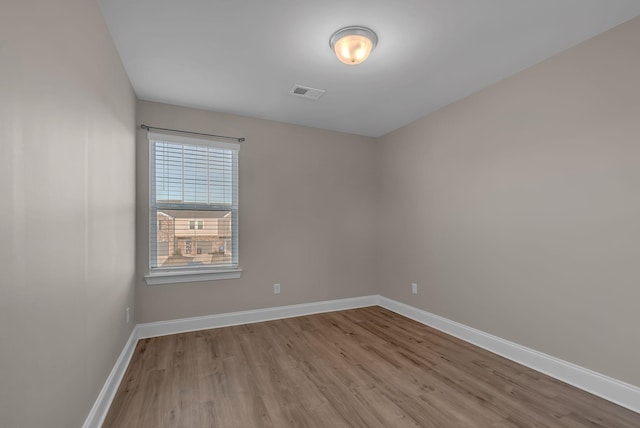 unfurnished room with light wood-type flooring