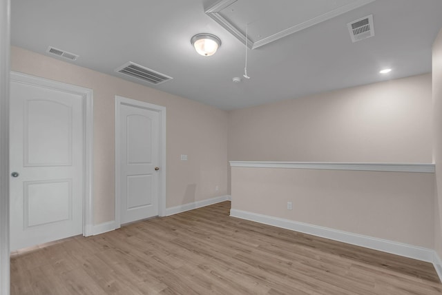 empty room with light hardwood / wood-style flooring