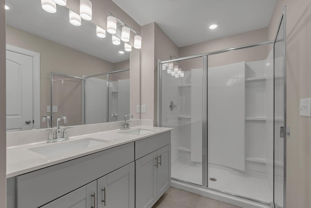 bathroom with tile patterned floors, an enclosed shower, and vanity