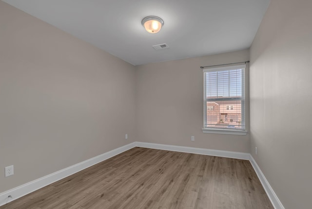 spare room with light hardwood / wood-style flooring