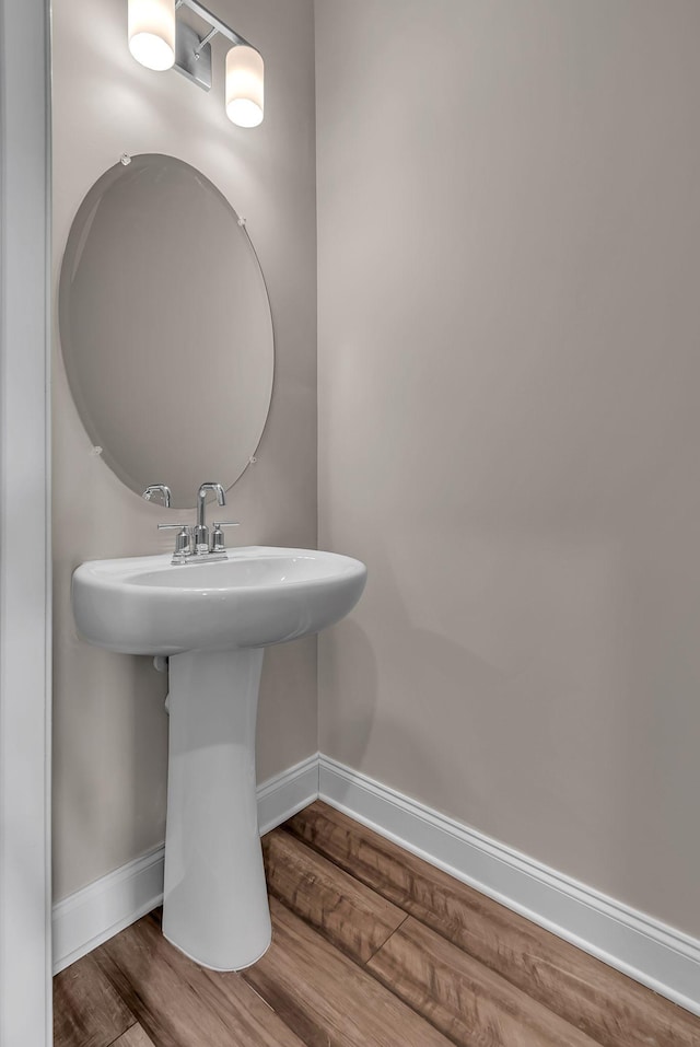 bathroom featuring wood-type flooring and sink