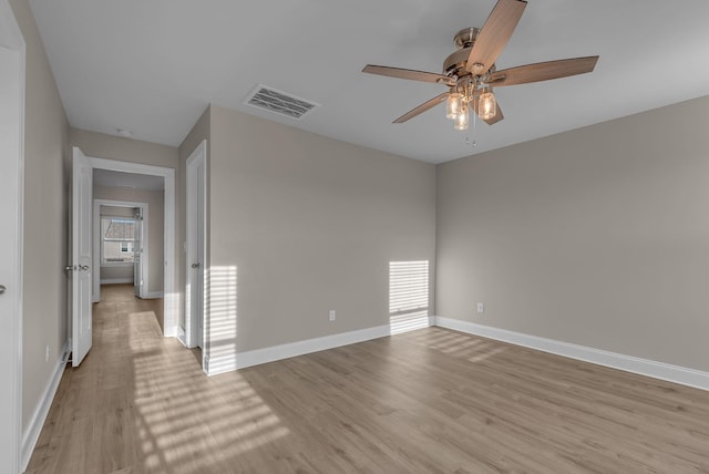 empty room with light hardwood / wood-style floors and ceiling fan