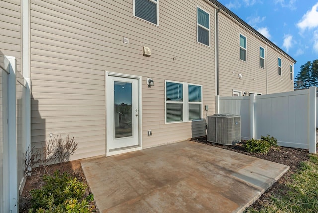 rear view of property featuring a patio area and central air condition unit