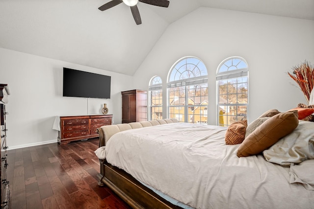 bedroom with ceiling fan, dark wood-type flooring, and high vaulted ceiling