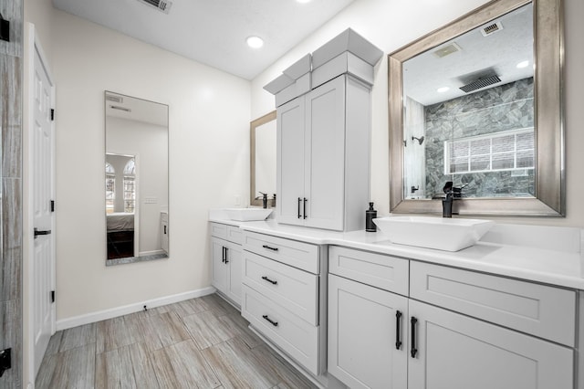 bathroom featuring vanity and tiled shower