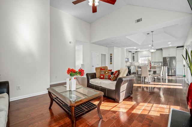 living room with wood-type flooring, high vaulted ceiling, and ceiling fan