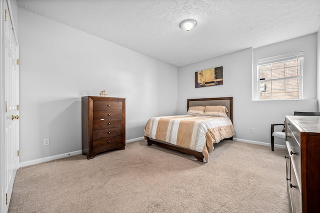 carpeted bedroom featuring a textured ceiling