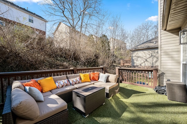 wooden terrace with outdoor lounge area and a lawn