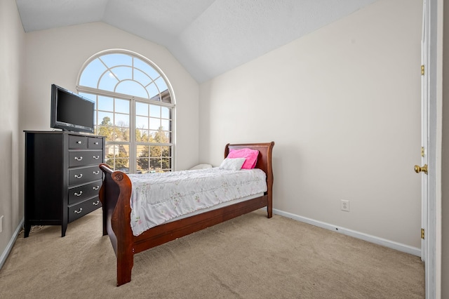 bedroom featuring vaulted ceiling and light carpet