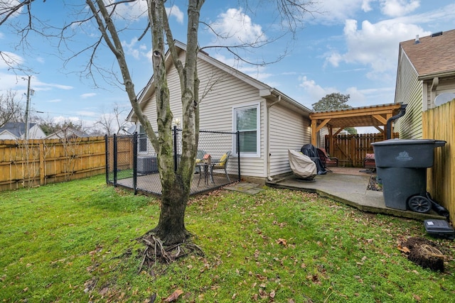 back of house featuring a yard, a pergola, and a patio area