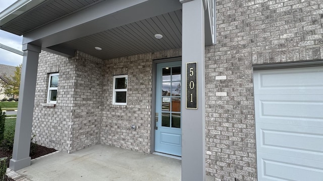 view of exterior entry with a garage