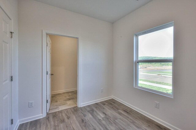 unfurnished room with light wood-type flooring