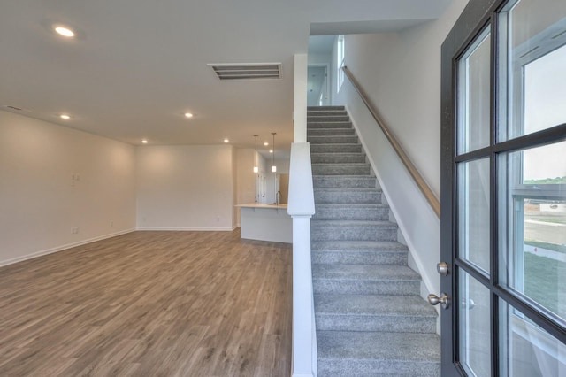 staircase featuring wood-type flooring