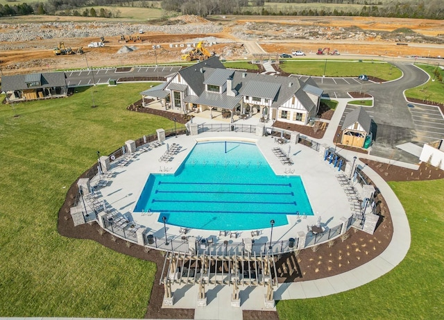 view of pool featuring a yard and a patio