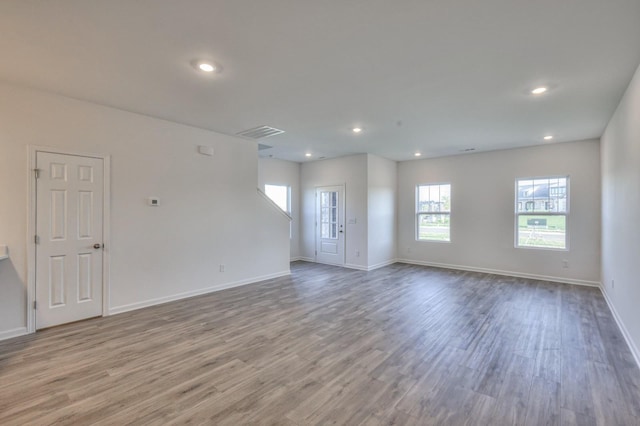 unfurnished living room with hardwood / wood-style flooring