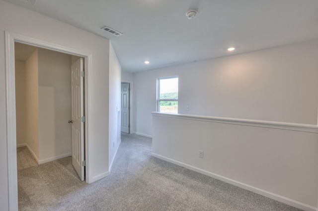 unfurnished room with light carpet