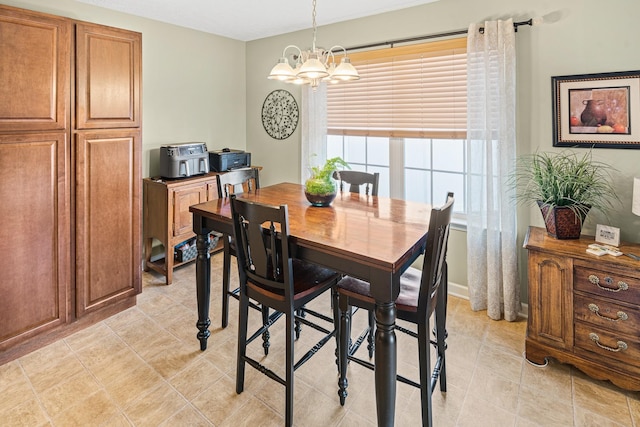 tiled dining space featuring an inviting chandelier