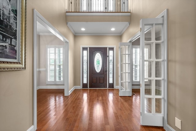 foyer featuring crown molding, hardwood / wood-style floors, recessed lighting, and baseboards