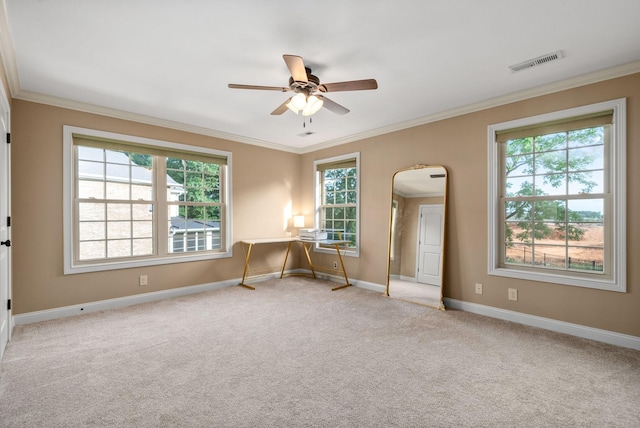 unfurnished room with ceiling fan, light colored carpet, and ornamental molding