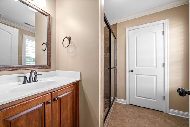 bathroom with tile patterned flooring, ornamental molding, vanity, and walk in shower