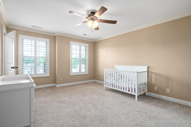 unfurnished bedroom featuring baseboards, carpet floors, visible vents, and crown molding