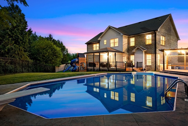 view of pool with a fenced in pool, a playground, a yard, and a deck