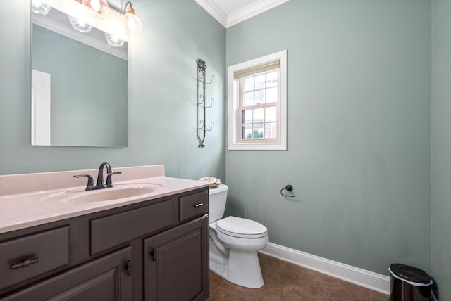 bathroom with tile patterned flooring, toilet, vanity, baseboards, and crown molding