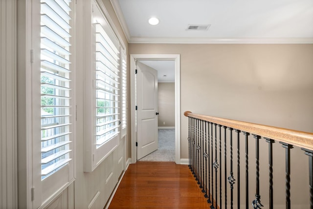 hall featuring wood-type flooring and ornamental molding