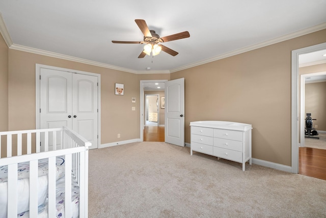 bedroom featuring crown molding, light carpet, and a closet