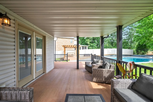 deck with a fenced backyard, a fenced in pool, an outdoor hangout area, and a pergola