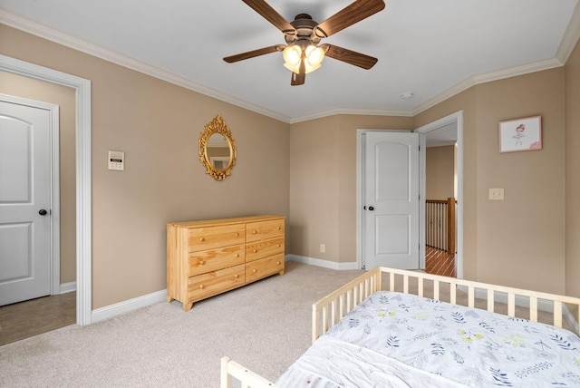 bedroom with ornamental molding, light colored carpet, and ceiling fan