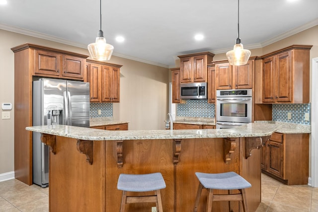 kitchen with stainless steel appliances, ornamental molding, and brown cabinetry