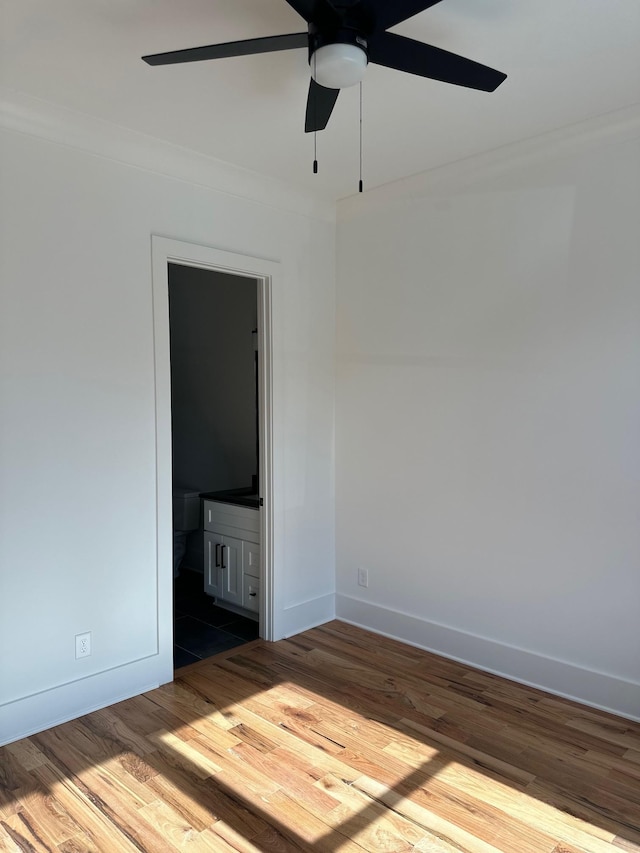 spare room featuring crown molding, ceiling fan, and wood-type flooring