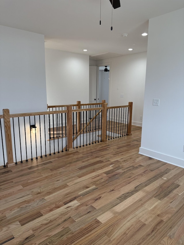 spare room featuring ceiling fan and light hardwood / wood-style flooring