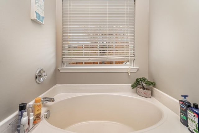 bathroom with a tub to relax in