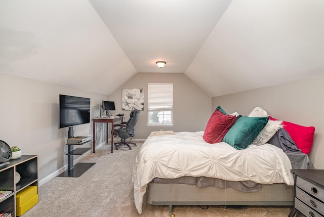 carpeted bedroom with lofted ceiling