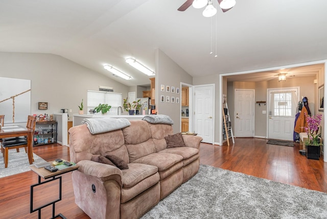 living room featuring vaulted ceiling, ceiling fan, and dark hardwood / wood-style flooring