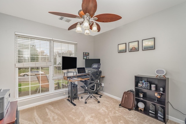 carpeted office space with ceiling fan