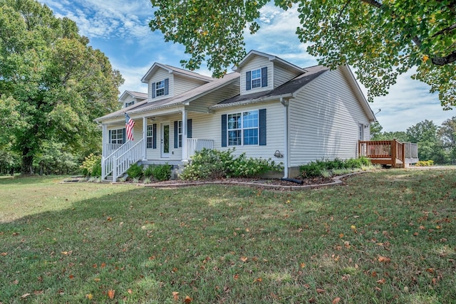 new england style home featuring a front lawn and a porch