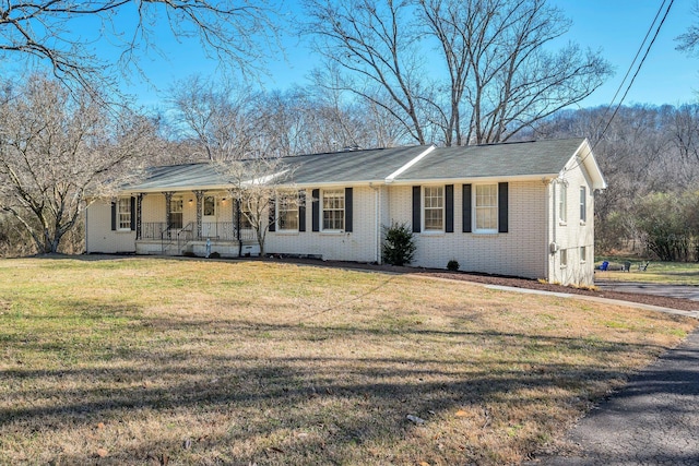 ranch-style home featuring a porch and a front lawn