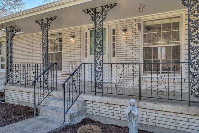 view of exterior entry with covered porch